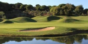 Cabopino Golf Course green overlooked by lake and bunker